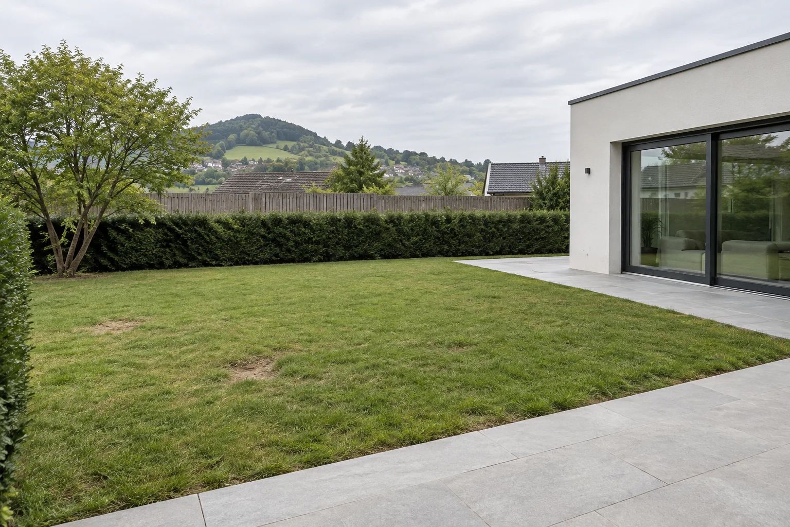 Gartenfläche neben einer Terrasse vor dem Poolbau
